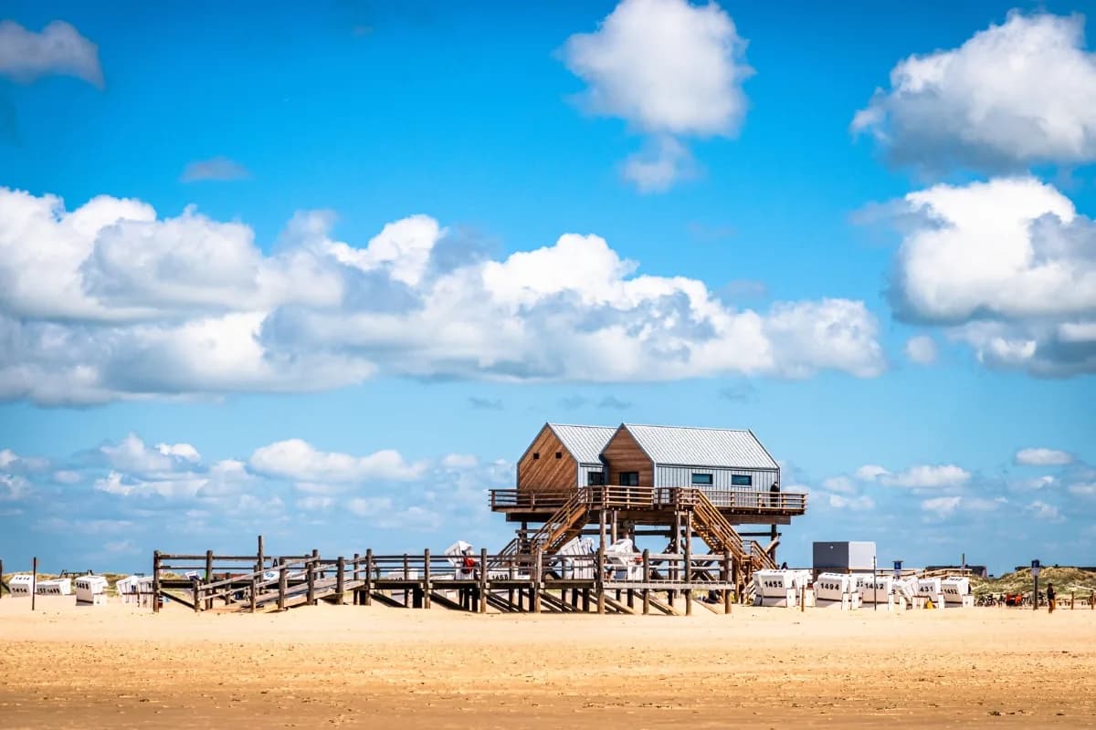 Pfahlbauten auf Stelzen am Strand von St. Peter-Ording mit Strandkörben